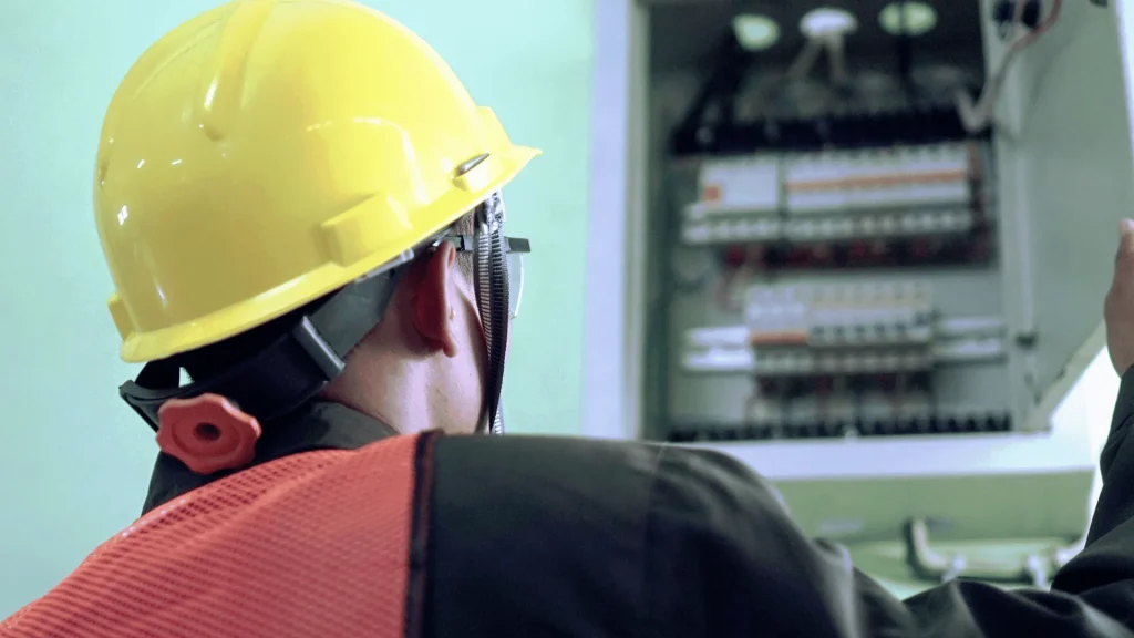 Professional electrician checking home electrical panel for EV installation