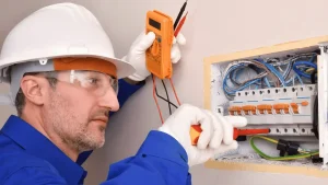 Electrician inspecting home electrical panel during safety check